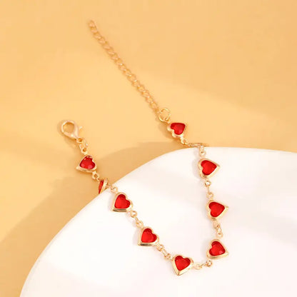 Elegante gouden armband met subtiele garnet steentjes